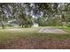 A view of the single-story home, detached garage and vacant lot at 2691 Phillips Rd, Christmas, FL 32709