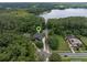 Aerial view of the home featuring a lush landscape, solar panels and access to a large lake in the distance at 2750 Lee Shore Loop, Orlando, FL 32820