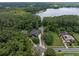 Aerial view of the home featuring a lush landscape, solar panels and access to a large lake in the distance at 2750 Lee Shore Loop, Orlando, FL 32820
