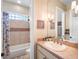 Well-lit bathroom featuring a single sink vanity, shower and neutral tilework at 2750 Lee Shore Loop, Orlando, FL 32820