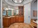 Bathroom featuring vanity with granite counters and wood cabinets and travertine floors at 2750 Lee Shore Loop, Orlando, FL 32820