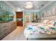 Bright bedroom featuring custom built-ins, a TV, and a queen size bed with designer fabrics at 2750 Lee Shore Loop, Orlando, FL 32820