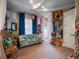 Fun bedroom featuring blue accent curtains, tropical daybed, and natural wicker chair at 2750 Lee Shore Loop, Orlando, FL 32820