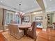 Elegant dining room featuring a wooden table with upholstered chairs, stylish chandelier, and hardwood floors at 2750 Lee Shore Loop, Orlando, FL 32820
