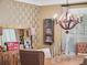 Close-up of a dining room with a rustic table, decorative chandelier, wooden shutters, and a charming display shelf at 2750 Lee Shore Loop, Orlando, FL 32820