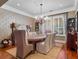 Bright dining room featuring a wooden table with upholstered chairs, wooden shutters, and a decorative chandelier at 2750 Lee Shore Loop, Orlando, FL 32820