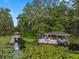 Scenic waterfront dock with boat lift, charming seating, and serene water views at 2750 Lee Shore Loop, Orlando, FL 32820