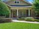 Charming home exterior with a well-manicured lawn, stone accents, and a welcoming front porch with seating at 2750 Lee Shore Loop, Orlando, FL 32820