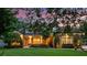 Inviting home with meticulous landscaping, stone accents, and warm lighting creating a welcoming ambiance at 2750 Lee Shore Loop, Orlando, FL 32820