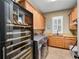 Convenient laundry room with modern washer/dryer, wine fridge and ample cabinet space at 2750 Lee Shore Loop, Orlando, FL 32820