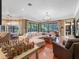 Bright open-plan living room with hardwood floors and large windows offering backyard view at 2750 Lee Shore Loop, Orlando, FL 32820