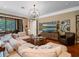 Spacious living area with a large sectional sofa, view to outdoor kitchen and sliding glass doors to lanai at 2750 Lee Shore Loop, Orlando, FL 32820