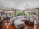 Open living room with hardwood floors, comfortable seating, and views of the outdoor pool area at 2750 Lee Shore Loop, Orlando, FL 32820
