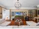 Open-concept living room featuring hardwood floors, modern light fixture, and comfortable seating arrangement at 2750 Lee Shore Loop, Orlando, FL 32820