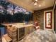 An elegant outdoor kitchen featuring a stainless steel grill, sink, beverage center, and a beautiful wood-paneled backsplash at 2750 Lee Shore Loop, Orlando, FL 32820