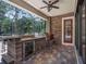 Outdoor kitchen complete with built-in grill, bar and outdoor dining space at 2750 Lee Shore Loop, Orlando, FL 32820