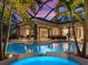 Stunning outdoor pool with a spa, lounge area, and tropical landscaping, creating a luxurious backyard retreat at 2750 Lee Shore Loop, Orlando, FL 32820