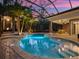 Luxury pool area with lush palms, beautiful lighting and covered patio, perfect for relaxing evenings outdoors at 2750 Lee Shore Loop, Orlando, FL 32820