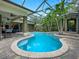 Stunning screened-in pool with tropical landscaping and a spacious brick-paved patio, ideal for outdoor relaxation and entertainment at 2750 Lee Shore Loop, Orlando, FL 32820