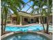 Large screened-in pool with a sun shelf surrounded by tropical landscaping offers a private backyard retreat at 2750 Lee Shore Loop, Orlando, FL 32820