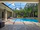 Screened-in pool and patio area offers a tranquil outdoor living space surrounded by lush landscaping at 2750 Lee Shore Loop, Orlando, FL 32820