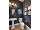 Elegant powder room featuring unique wallpaper, an ornate mirror, and modern fixtures at 2750 Lee Shore Loop, Orlando, FL 32820