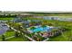 Breathtaking aerial view of the community pool, clubhouse, and beautiful landscaping at 2807 Alder Berry Blvd, Ocoee, FL 34761