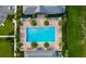 Stunning aerial view of the community pool with ample seating, lush landscaping, and inviting atmosphere at 2807 Alder Berry Blvd, Ocoee, FL 34761