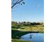 Scenic community view featuring lush green spaces, walking path, and serene pond reflecting the sky at 2807 Alder Berry Blvd, Ocoee, FL 34761