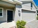 Close up of the front door and garage door of this beautiful home at 2807 Alder Berry Blvd, Ocoee, FL 34761