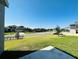 Well-maintained front yard featuring vibrant green grass and street view of the neighborhood at 2807 Alder Berry Blvd, Ocoee, FL 34761