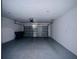 View of garage with metal door and painted walls at 2807 Alder Berry Blvd, Ocoee, FL 34761