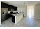 The kitchen features stainless steel appliances, dark cabinetry, and a center island at 2807 Alder Berry Blvd, Ocoee, FL 34761