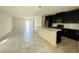 Bright kitchen featuring a large island and stainless steel appliances and dark cabinets at 2807 Alder Berry Blvd, Ocoee, FL 34761