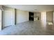 Open floorplan with tile floors seamlessly connecting the living room and kitchen area at 2807 Alder Berry Blvd, Ocoee, FL 34761