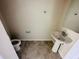 Simple half bathroom with a pedestal sink, mirror and neutral colors at 2807 Alder Berry Blvd, Ocoee, FL 34761