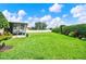 Large back yard with a screened in patio, privacy fence, and green grass at 289 Laurenburg Ln, Ocoee, FL 34761