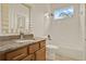Bright bathroom with granite vanity, neutral tile floor and tub/shower combo at 289 Laurenburg Ln, Ocoee, FL 34761