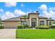 Stunning single-story home with a manicured lawn, arched entryway, and neutral color palette at 289 Laurenburg Ln, Ocoee, FL 34761