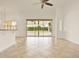 Open-concept living area with tile flooring and sliding glass doors to the screened patio at 289 Laurenburg Ln, Ocoee, FL 34761