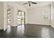 Large bedroom with hardwood floors, fan, and sliding glass door to screened patio at 289 Laurenburg Ln, Ocoee, FL 34761