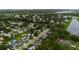 Scenic aerial view of a residential neighborhood with tree-lined streets near a tranquil lake at 2943 Slippery Rock Ave, Orlando, FL 32826