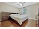 Comfortable bedroom with wood floors, ceiling fan, and natural light at 2943 Slippery Rock Ave, Orlando, FL 32826