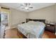 Well-lit bedroom features a ceiling fan, wood floors, and bright natural light at 2943 Slippery Rock Ave, Orlando, FL 32826