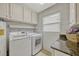 Functional laundry room featuring washer, dryer, and cabinet storage at 2943 Slippery Rock Ave, Orlando, FL 32826