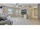 Bright living room with tile flooring, ceiling fan, and large TV for comfortable living at 2943 Slippery Rock Ave, Orlando, FL 32826