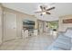 Open living room features tile floors, neutral decor, a ceiling fan and a view to the kitchen at 2943 Slippery Rock Ave, Orlando, FL 32826
