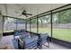Relaxing screened-in porch with ceiling fan, backyard views, and comfortable outdoor seating at 2943 Slippery Rock Ave, Orlando, FL 32826