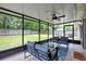 Relaxing screened-in porch with ceiling fan, backyard views, and comfortable outdoor seating at 2943 Slippery Rock Ave, Orlando, FL 32826