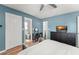 Comfortable bedroom with wood flooring, ensuite bathroom, and a wall-mounted TV at 3232 Butterfield St, Deltona, FL 32738